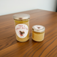 Two jars of 'Pika's Peanut Butter' on a wooden table